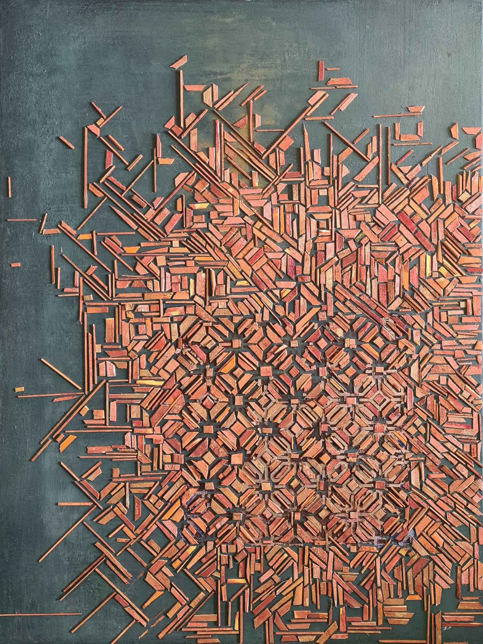 Exploded composition of orange wood fragments on a background of natural iron pigments.