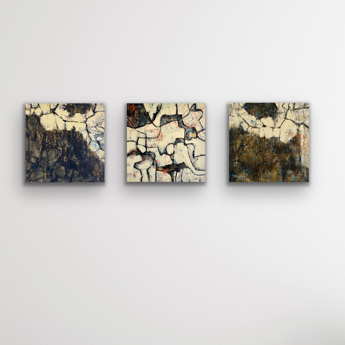 Three small paintings together on a white wall