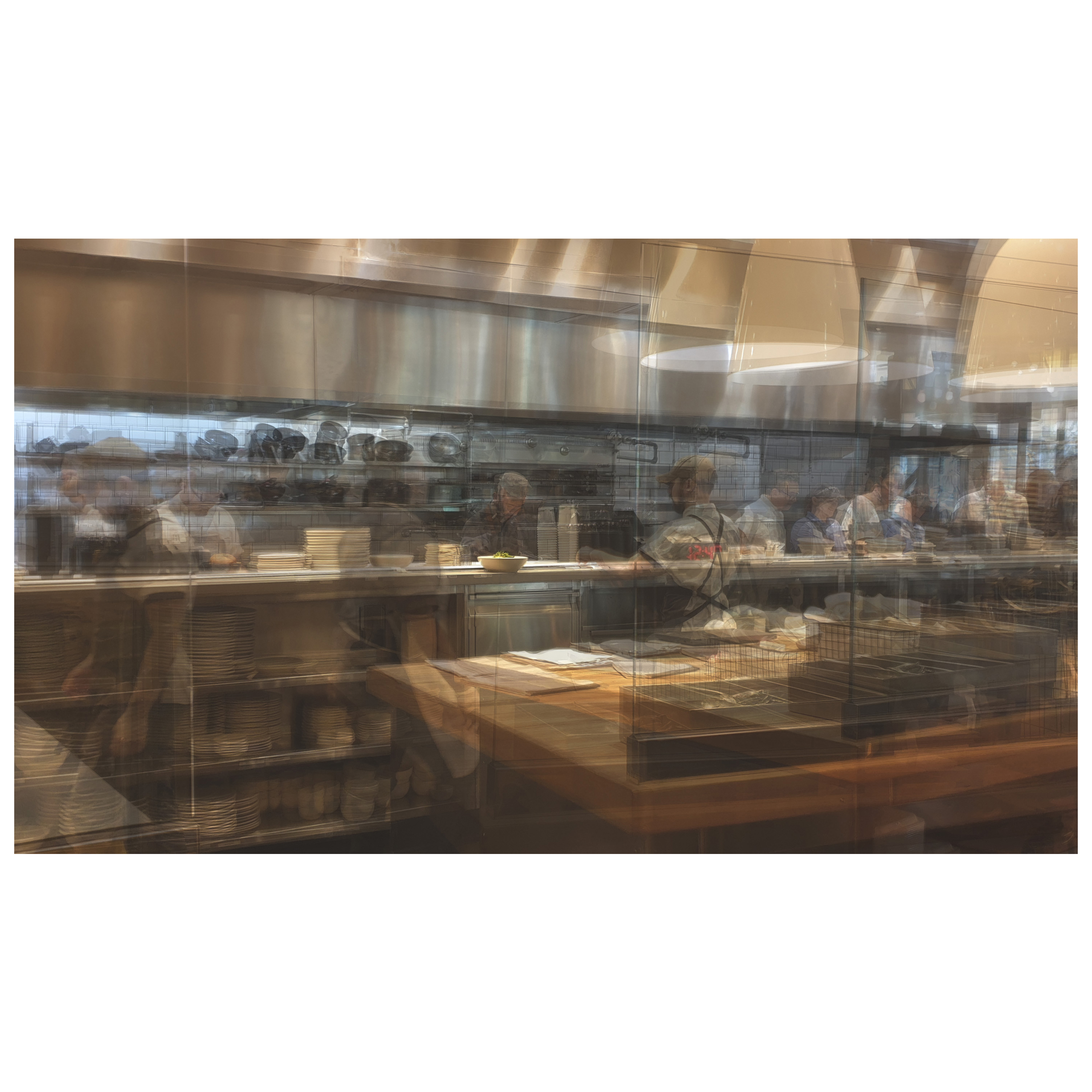 A multilayered photo of a restaurant kitchen