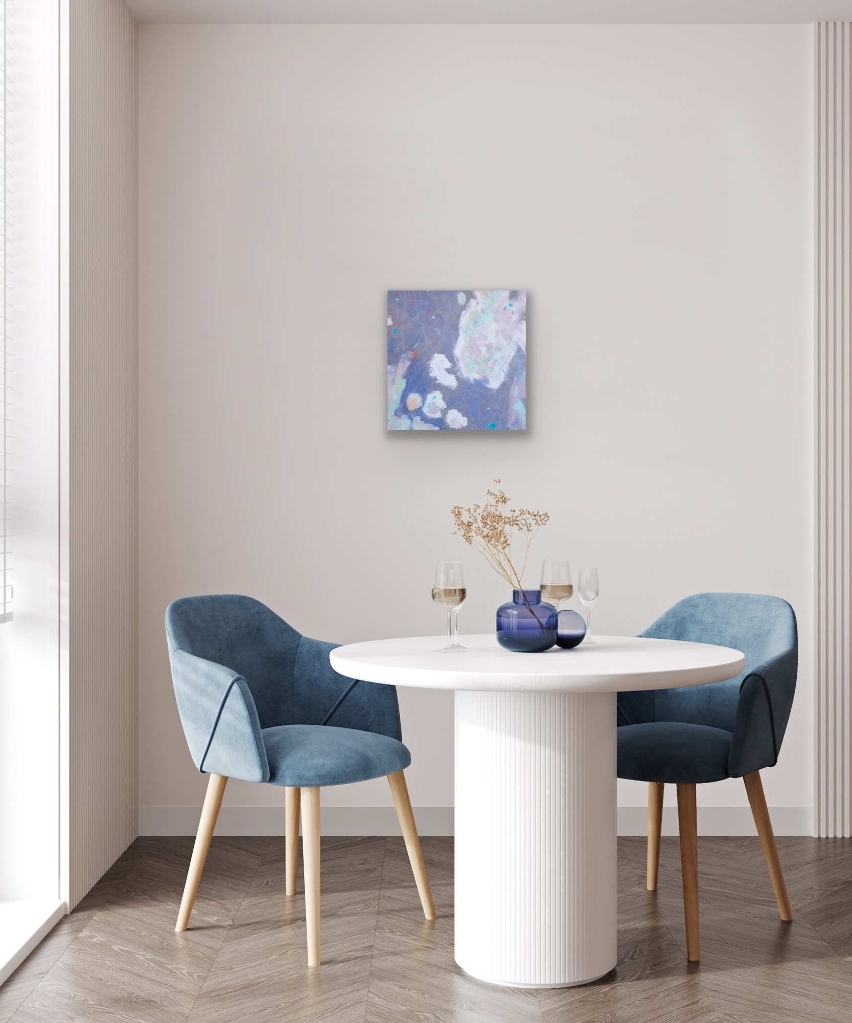A soft grey painting in a dining room above a table and chairs