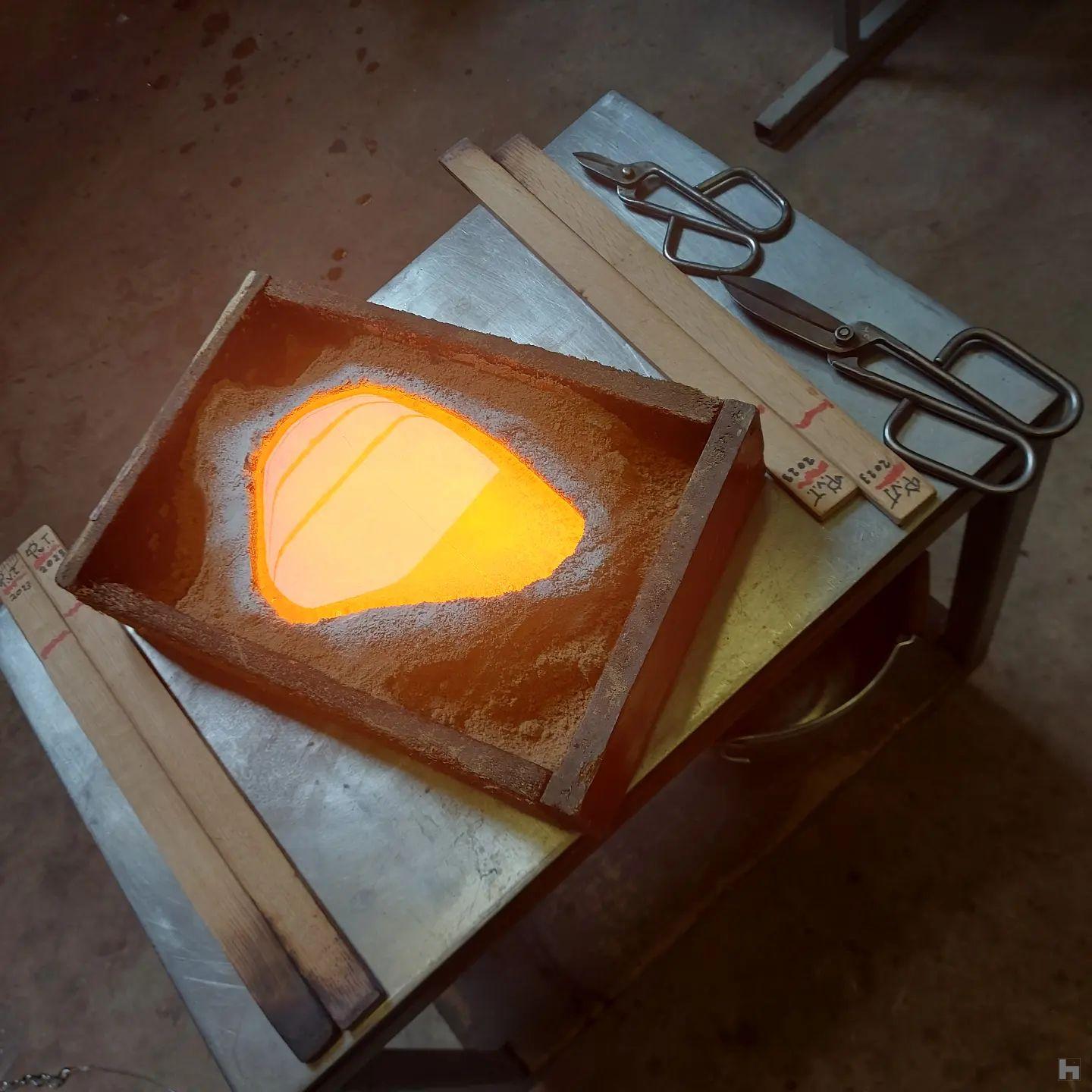 for this particular sculpture, glass has been cast in a sand mould. When the glass has set, the sand mould is removed an dthe piece put in a kiln at approx 500°C for 24 to 48h