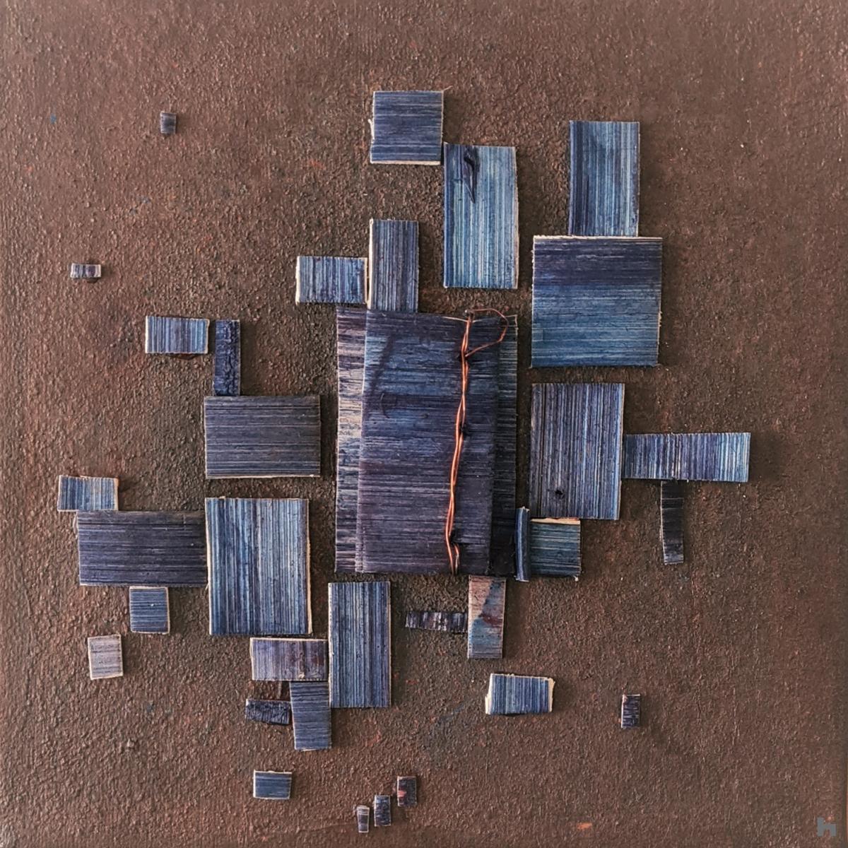 Geometric composition.Collage of blue colored wood on a sienna earth background