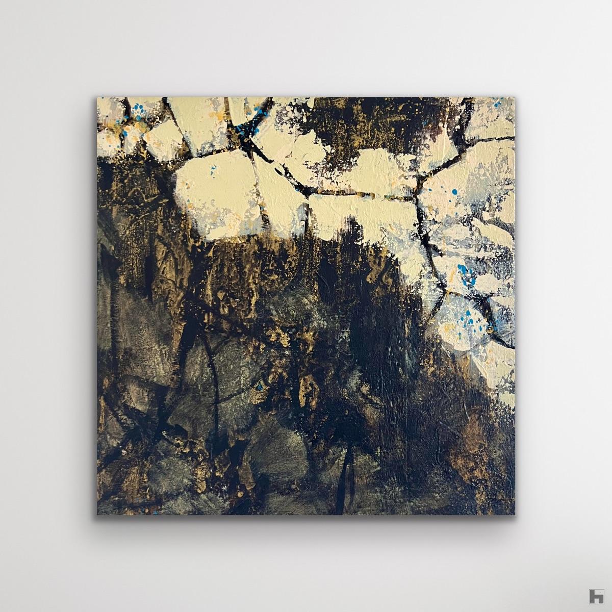 A small and lively painting in black and gold on a white wall