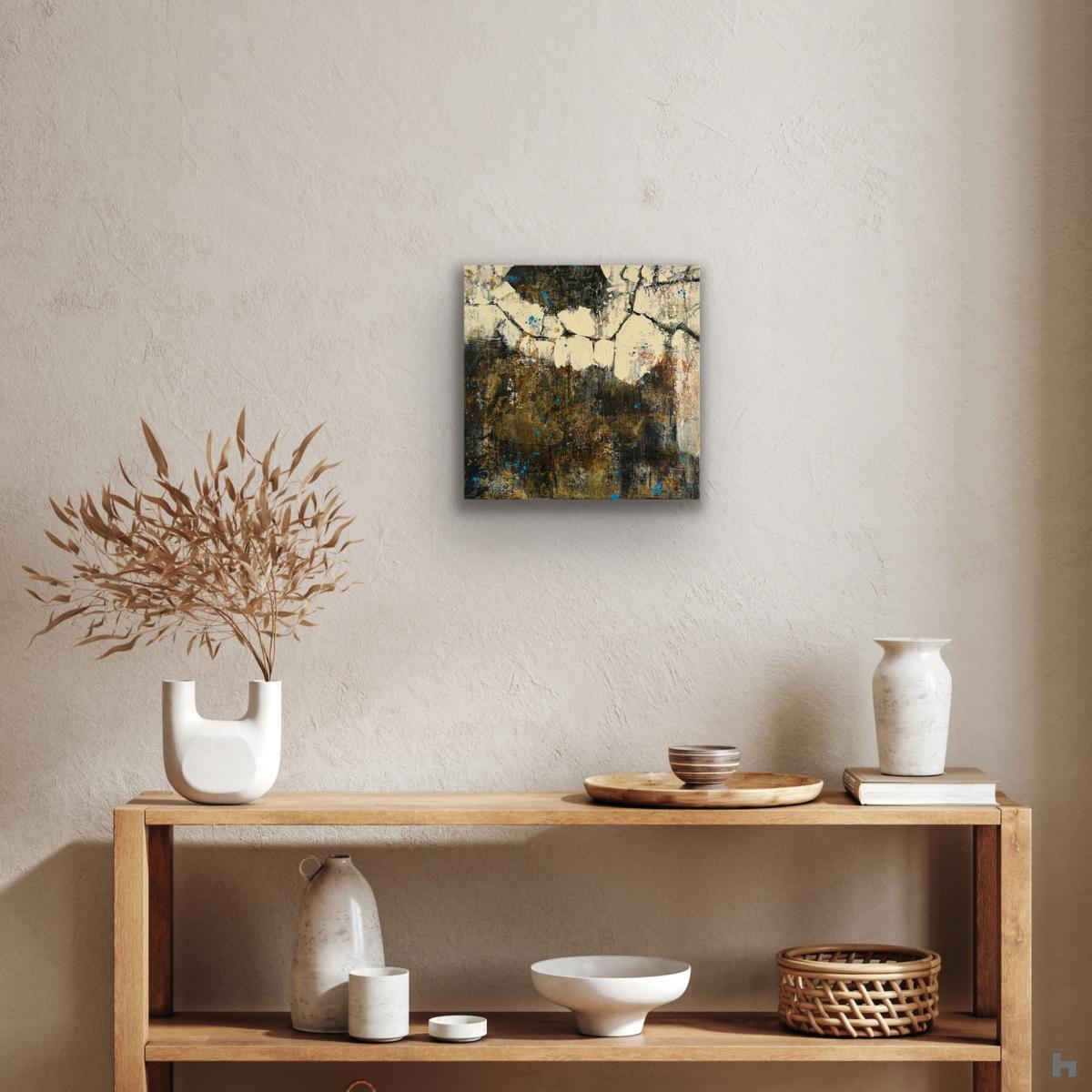 A small black, cream and gold painting about a shelf with ornaments