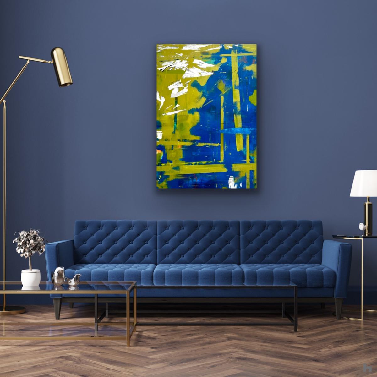 A blue and green abstract painting on a blue wall