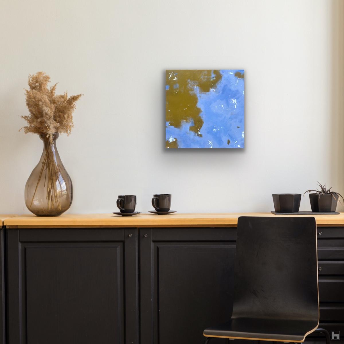 A small blue painting on the wall above a chest of drawers