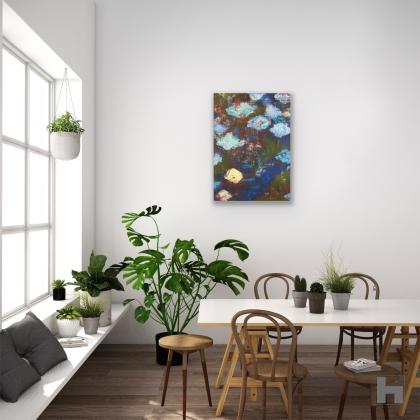 A green and blue abstract painting in a room with a table and house plants